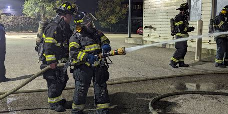 Citizens Fire Academy student uses hose