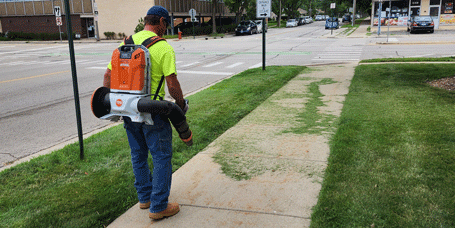 Public Works staff using electric leaf blower